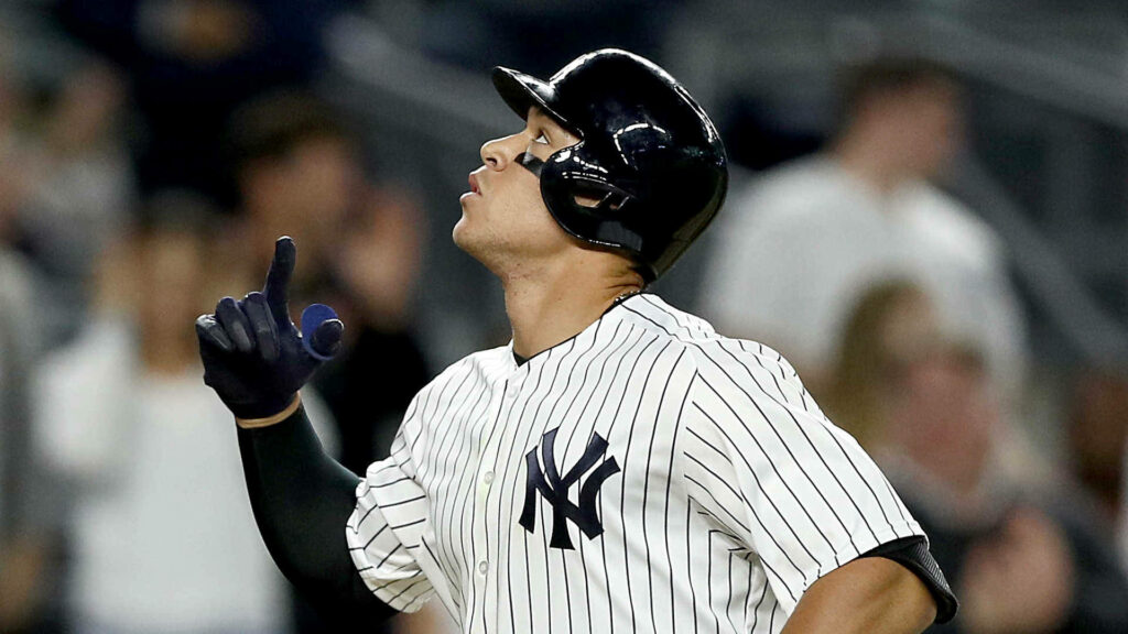 Aaron Judge in New York Yankees uniform focused looking up dynamic baseball wallpaper background