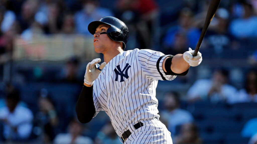 Aaron Judge mid-swing in New York Yankees uniform showing power and focus on field wallpaper