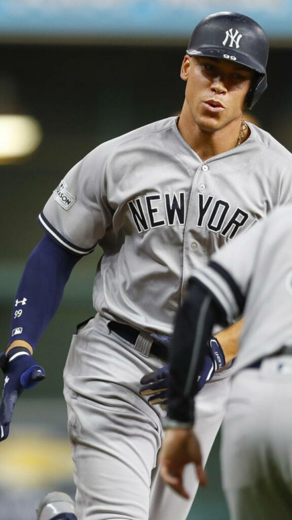 Aaron Judge rounds bases in New York Yankees uniform showing power intensity and athleticism Wallpaper