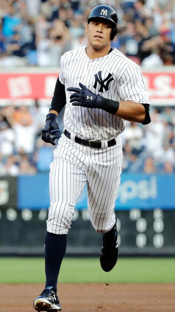 Aaron Judge running full stride in New York Yankees uniform showing focus and athleticism Wallpaper