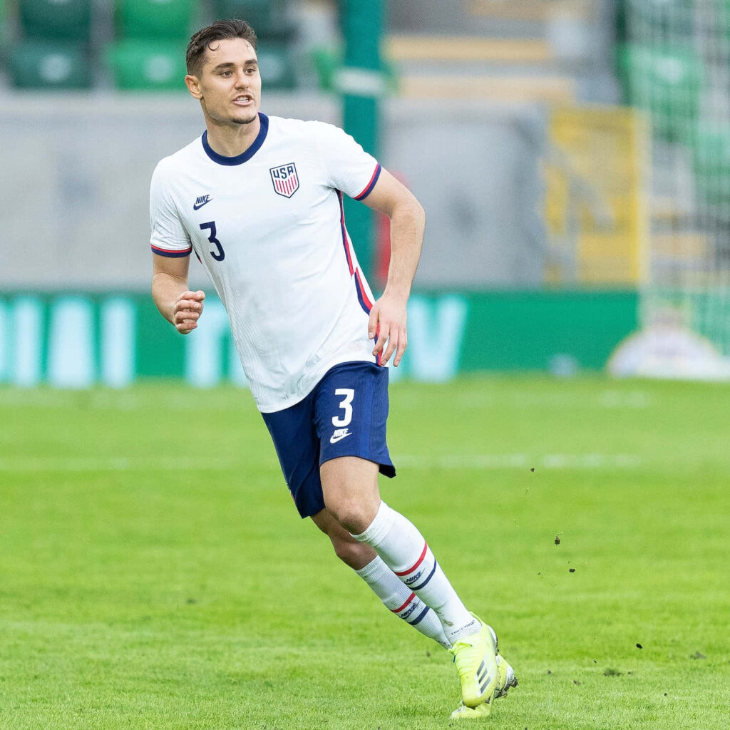 Aaron Long in action during international soccer friendly showing focus and athleticism wallpaper