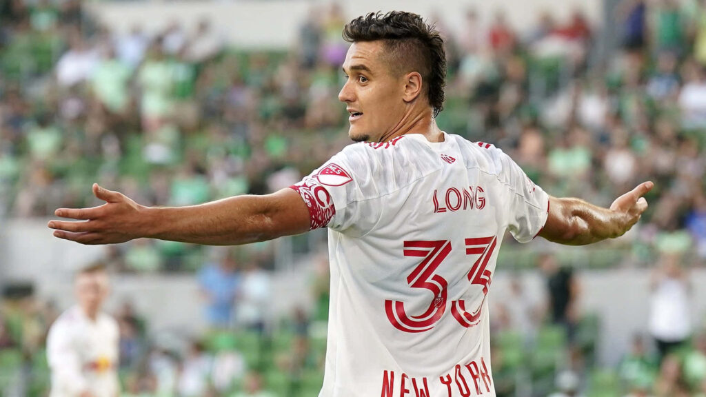 Aaron Long in white number 33 New York jersey showing intense focus on the soccer field wallpaper