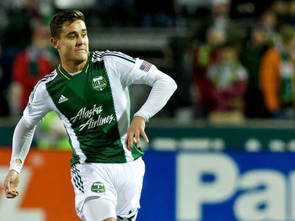 Aaron Long in Portland Timbers kit sprinting on soccer field dramatic action moment wallpaper