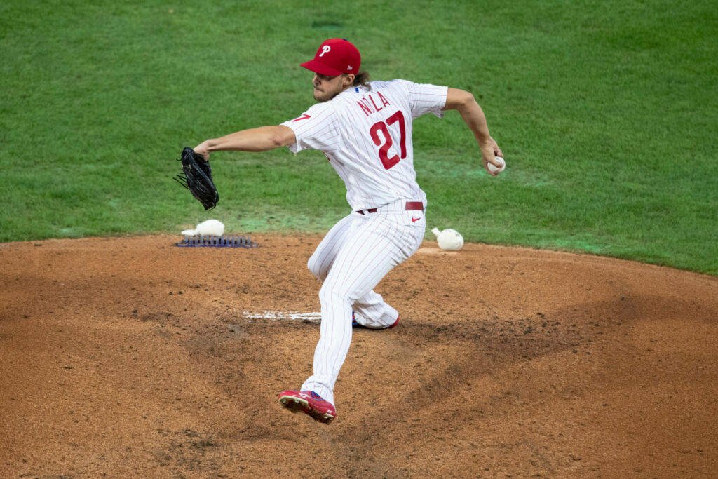 Aaron Nola pitching fastball mid-motion on mound during baseball game wallpaper background