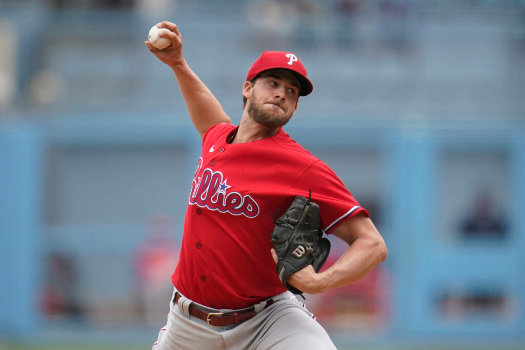 Aaron Nola pitching fiercely for Philadelphia Phillies dynamic baseball wallpaper background