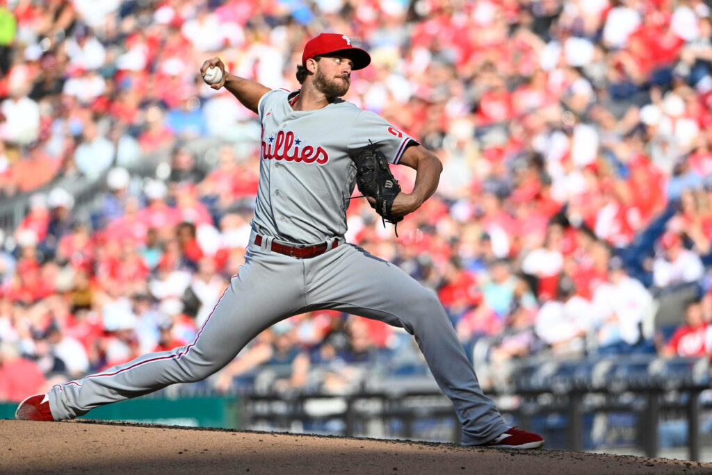Aaron Nola pitching for Philadelphia Phillies showing powerful form on the mound during game wallpaper