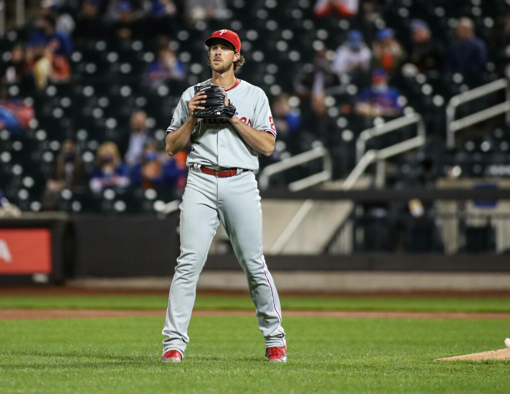 Aaron Nola pitching in Philadelphia Phillies uniform focused on mound at lively baseball stadium Wallpaper