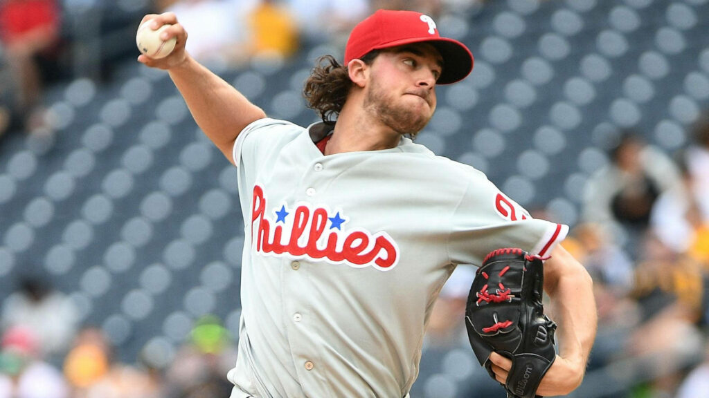 Aaron Nola pitching fiercely in Philadelphia Phillies uniform showcasing MLB pitching intensity wallpaper