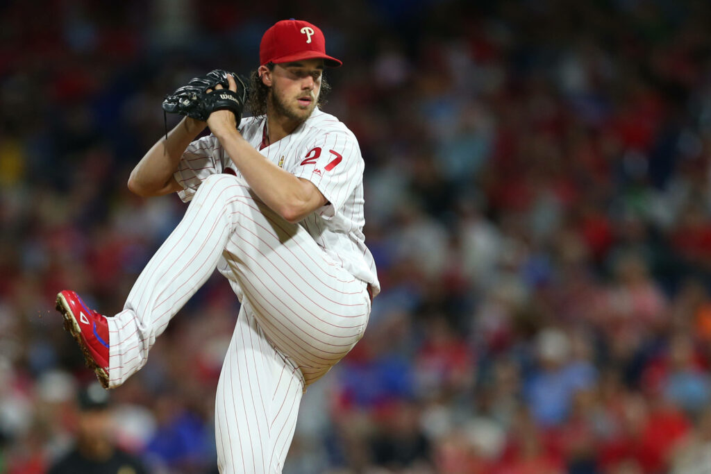 Aaron Nola pitching in Philadelphia Phillies uniform focused on mound during baseball game wallpaper