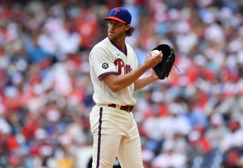 Aaron Nola pitching intensely in Philadelphia Phillies uniform over-the-shoulder game view wallpaper