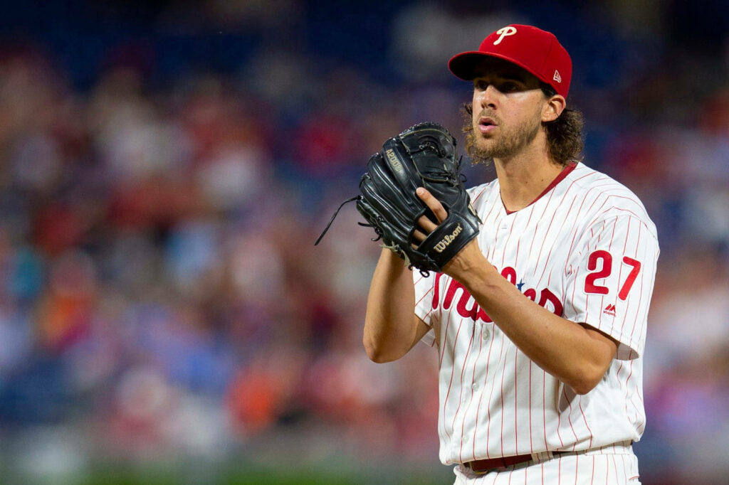 Aaron Nola pitching for Philadelphia Phillies focused on mound during intense baseball game wallpaper