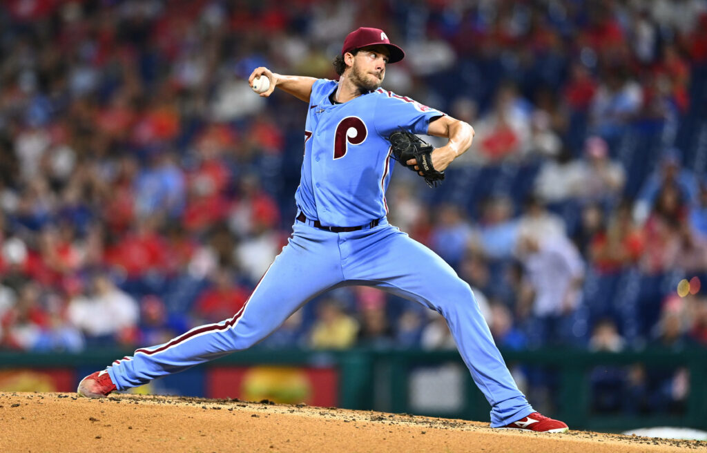 Aaron Nola pitching for Philadelphia Phillies focused on the mound in game action wallpaper background