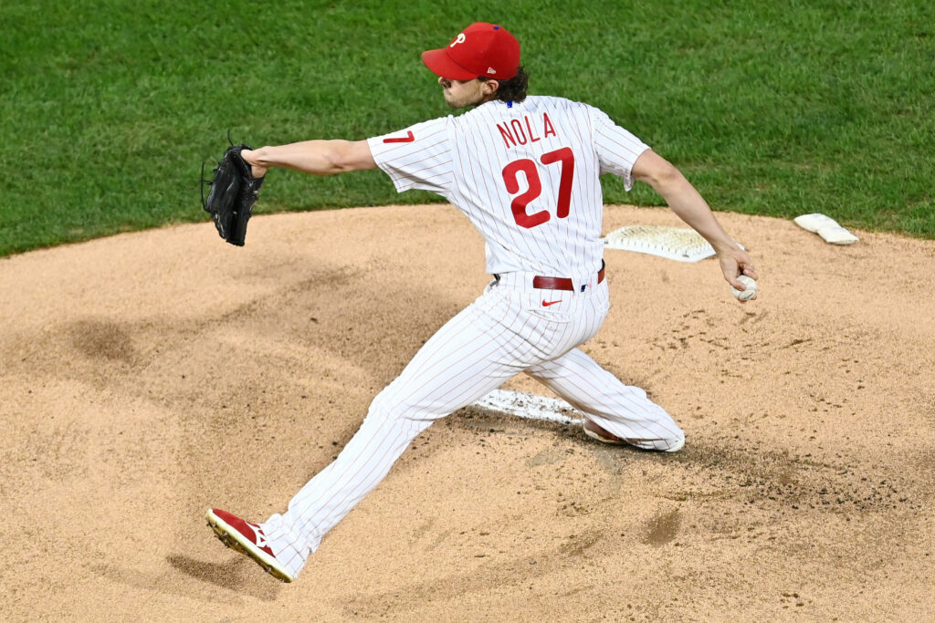 Aaron Nola pitching powerfully on mound demonstrating skill focus dynamic baseball wallpaper