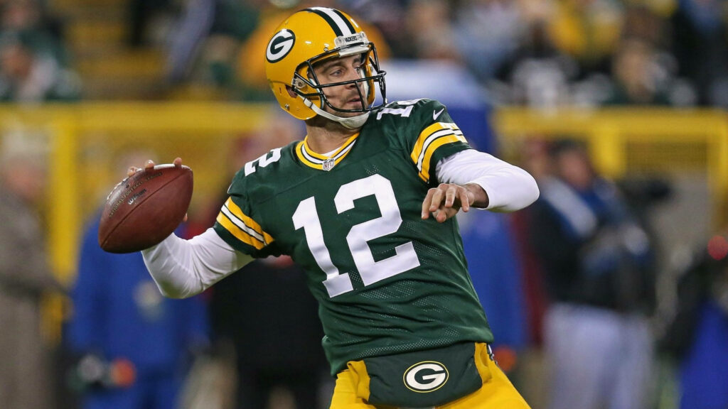 Aaron Rodgers Green Bay Packers quarterback throwing a football during game wallpaper background