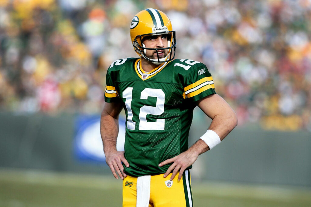 Aaron Rodgers in Green Bay Packers uniform on field ready for football game action wallpaper
