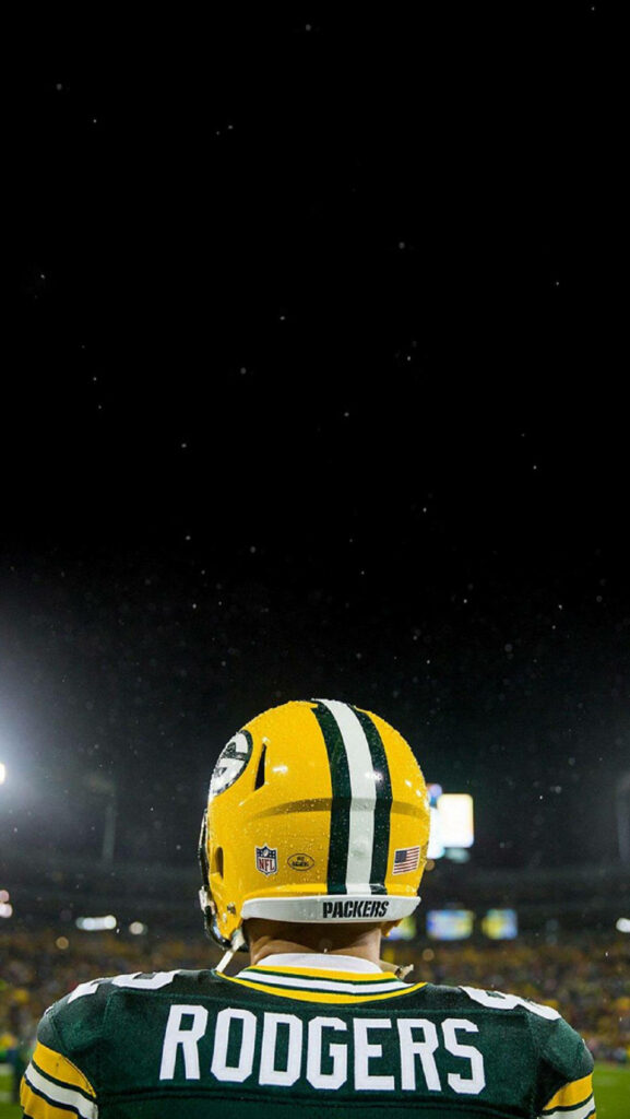 Aaron Rodgers Green Bay Packers on field under stadium lights during intense NFL game night wallpaper