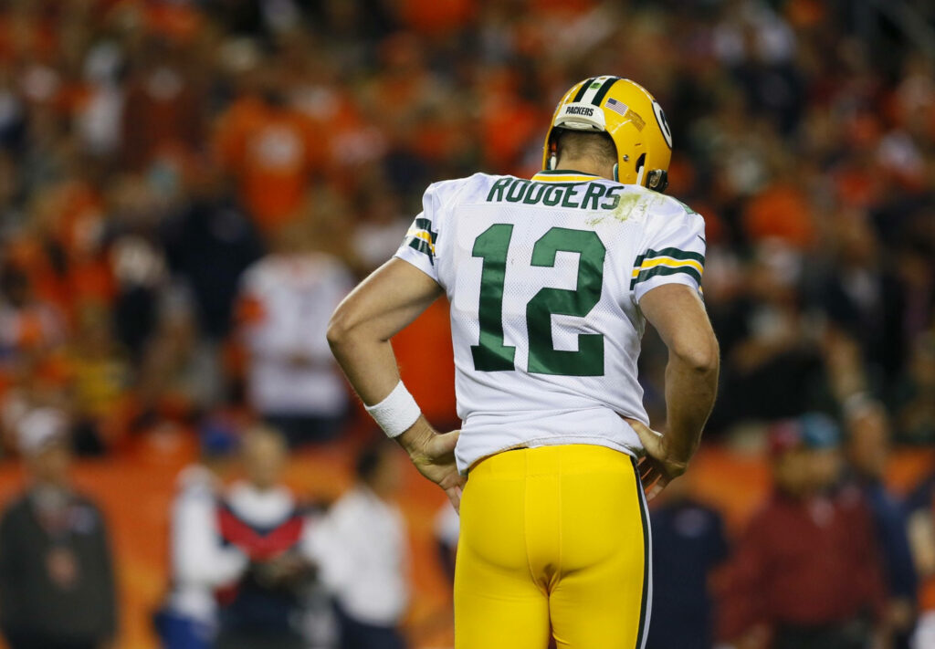 Aaron Rodgers in green Packers uniform wearing number 12 on field dynamic quarterback wallpaper