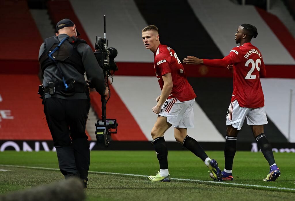 Aaron Wan-Bissaka football wallpaper dynamic match intensity teammate on field background