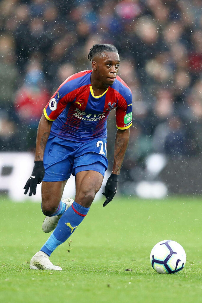 Aaron Wan-Bissaka in action football wallpaper focused making decisive move on the field