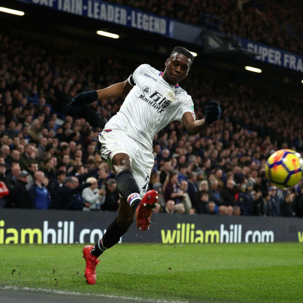 Aaron Wan-Bissaka mid-action football wallpaper showing athleticism and intense focus on pitch