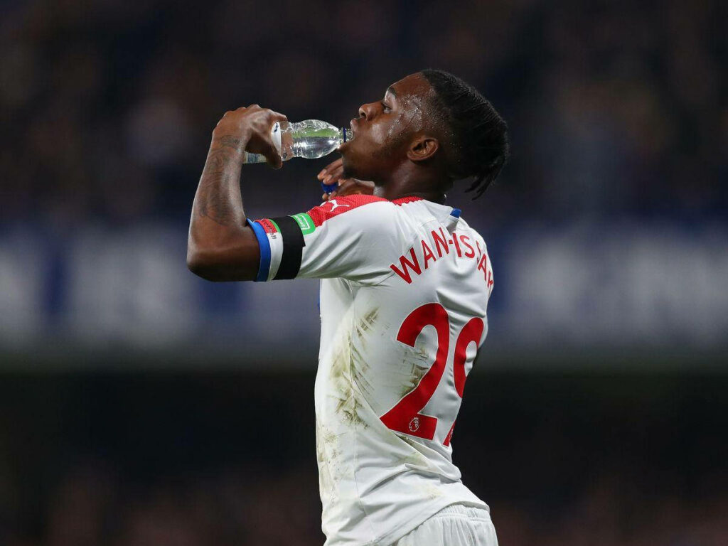 Aaron Wan-Bissaka drinking water during football match wearing team kit with name and number visible Wallpaper