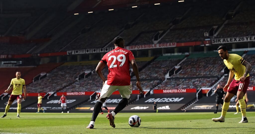 Aaron Wan-Bissaka displaying defensive skills in training game at stadium with focused intensity Wallpaper