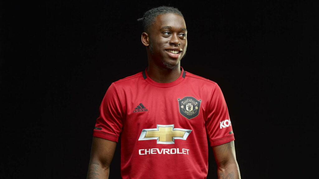 Aaron Wan-Bissaka in Manchester United kit confident pose dark background wallpaper fans