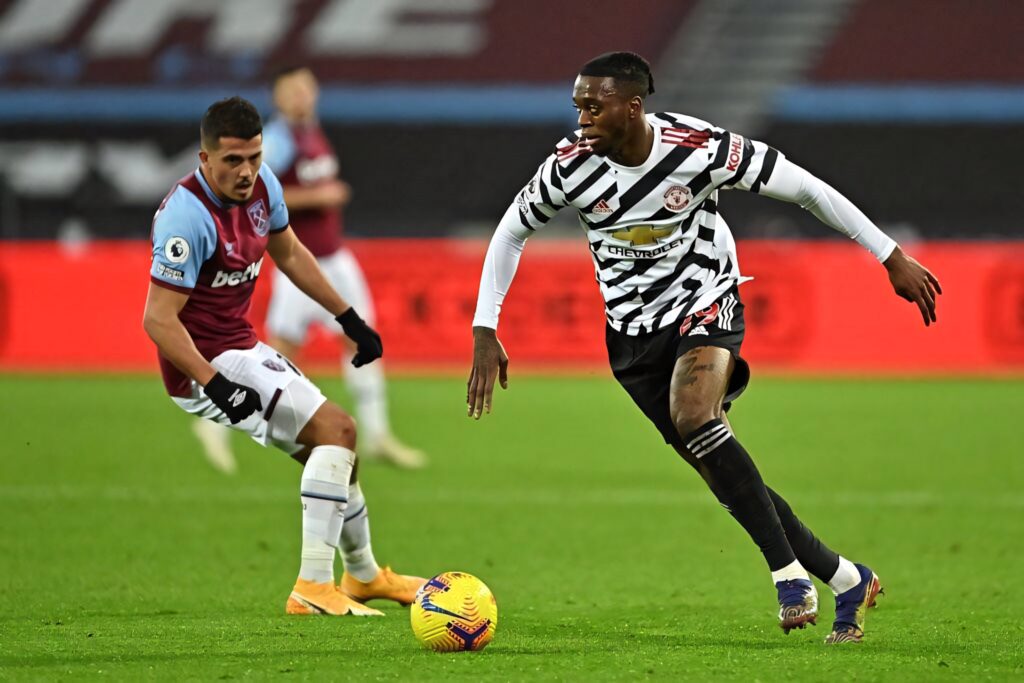 Aaron Wan-Bissaka skillfully controls ball in Manchester United zebra-striped away kit during match Wallpaper