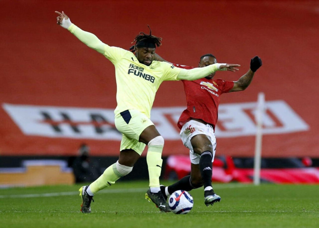 Aaron Wan-Bissaka defensive challenge premier league match intense football action wallpaper