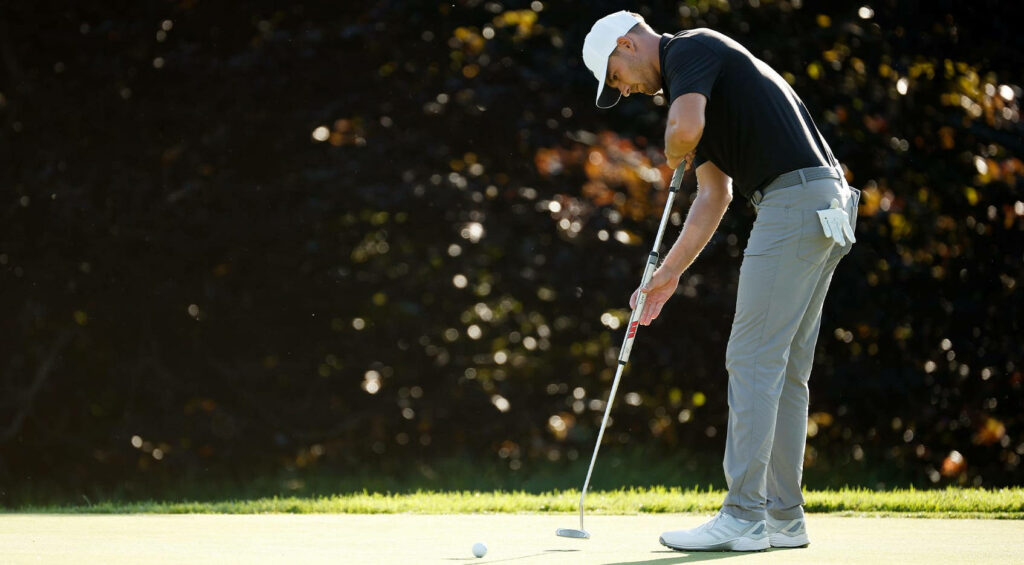 Aaron Wise concentrating on the green preparing to putt during a golf tournament wallpaper background