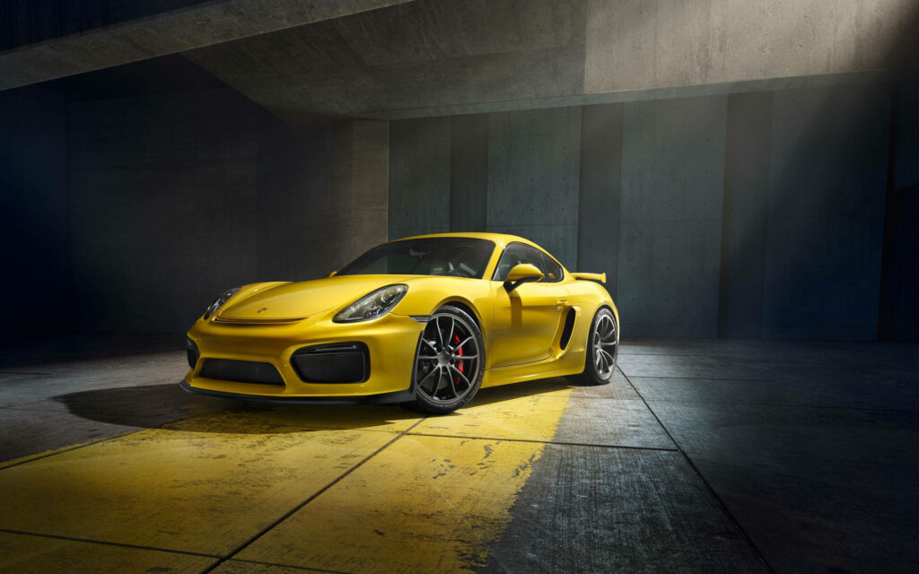 Abandoned Beauty: Vibrant Yellow Porsche Cayman GT4 2015 Wallpaper