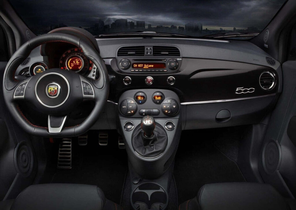 Abarth 595 sporty interior with premium materials and performance-focused dashboard wallpaper background