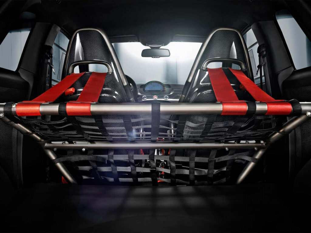 Abarth car interior with racing bucket seats red harnesses and performance roll cage motorsport wallpaper