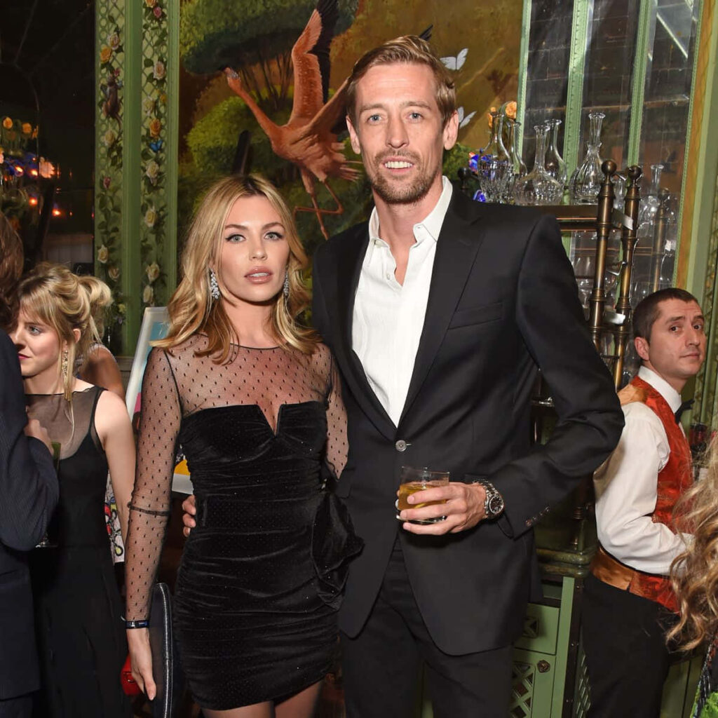 Abbey Clancy and partner in stylish evening wear posing elegantly at glamorous event wallpaper background