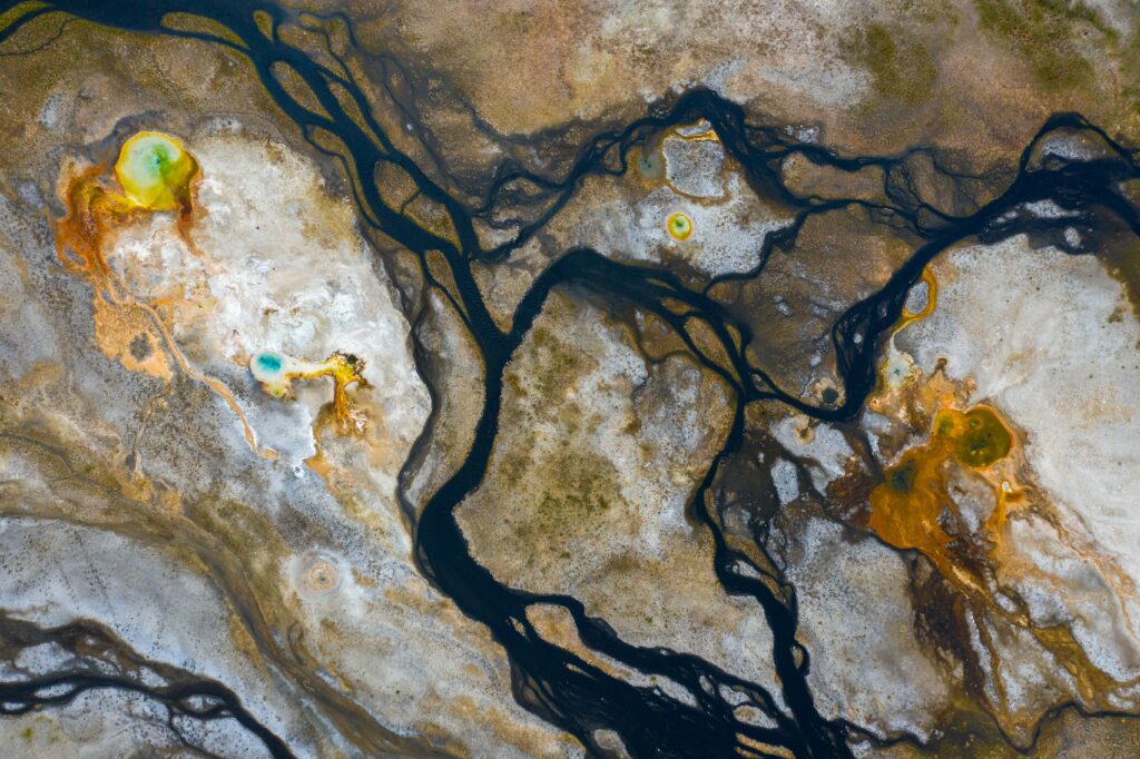 Abstract Aerial Landscape Wallpaper: Earthy Tones & Vibrant Stains
