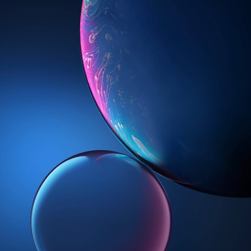 Apple iPhone XR wallpaper with two translucent spheres in neon pink and blue abstract design