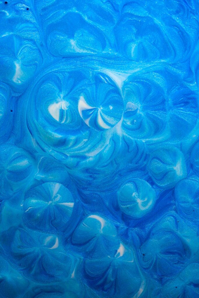 Abstract Blue Liquid Paint Wallpaper with Circular Swirl Patterns