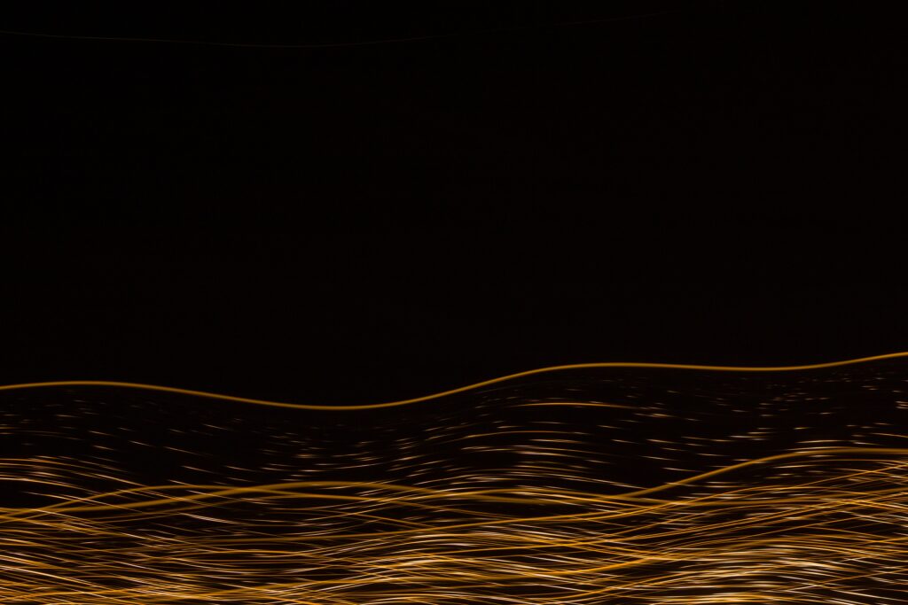 Dynamic Abstract Wallpaper with Golden Lines on Dark Background