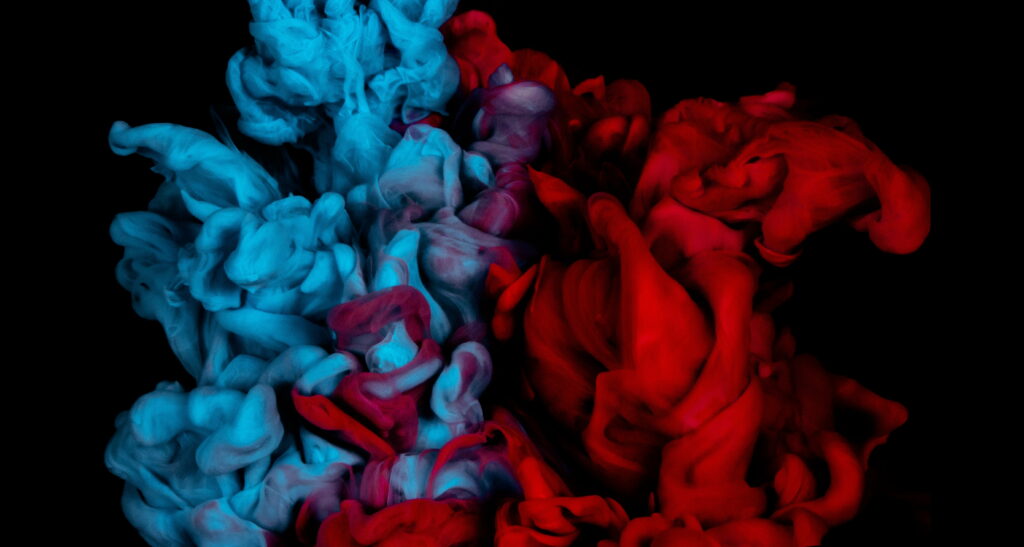 Vibrant Symphony: A Rhythmic Blend of Ink and Paint in Red and Blue - A Captivating 4K Wallpaper Background