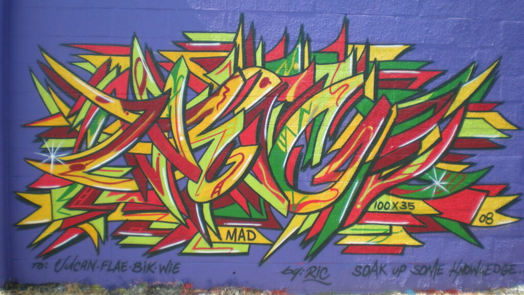 Urban Kaleidoscope: A Vibrant Abstract Masterpiece in Graffiti Wallpaper
