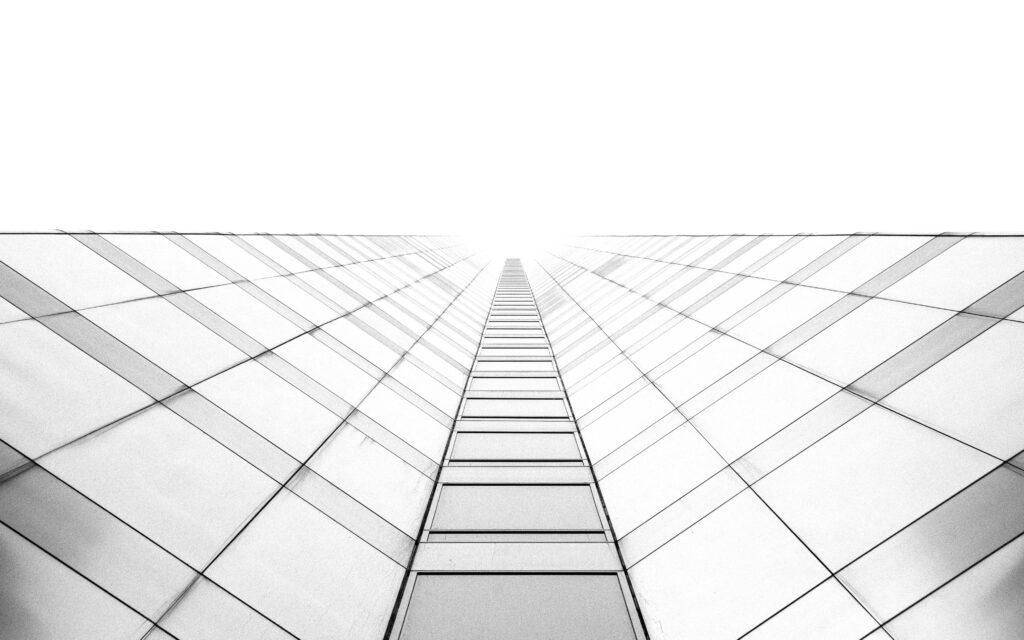 Minimalist monochrome worm's-eye view of white skyscraper with geometric lines wallpaper background