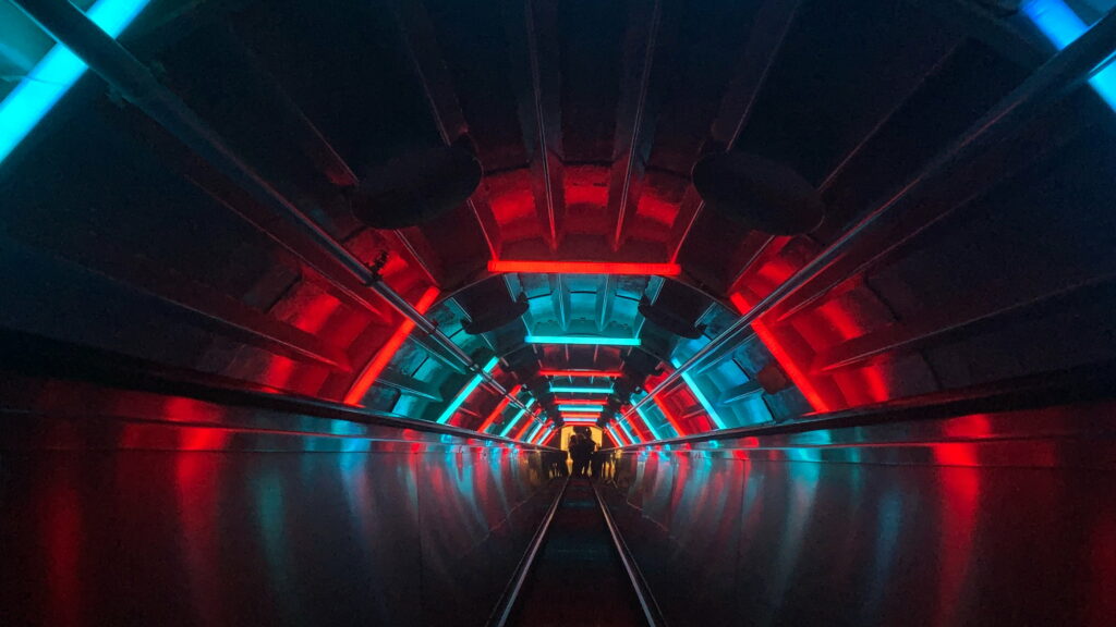 Neon Infused Tunnel: Abstract and Dark QHD Wallpaper