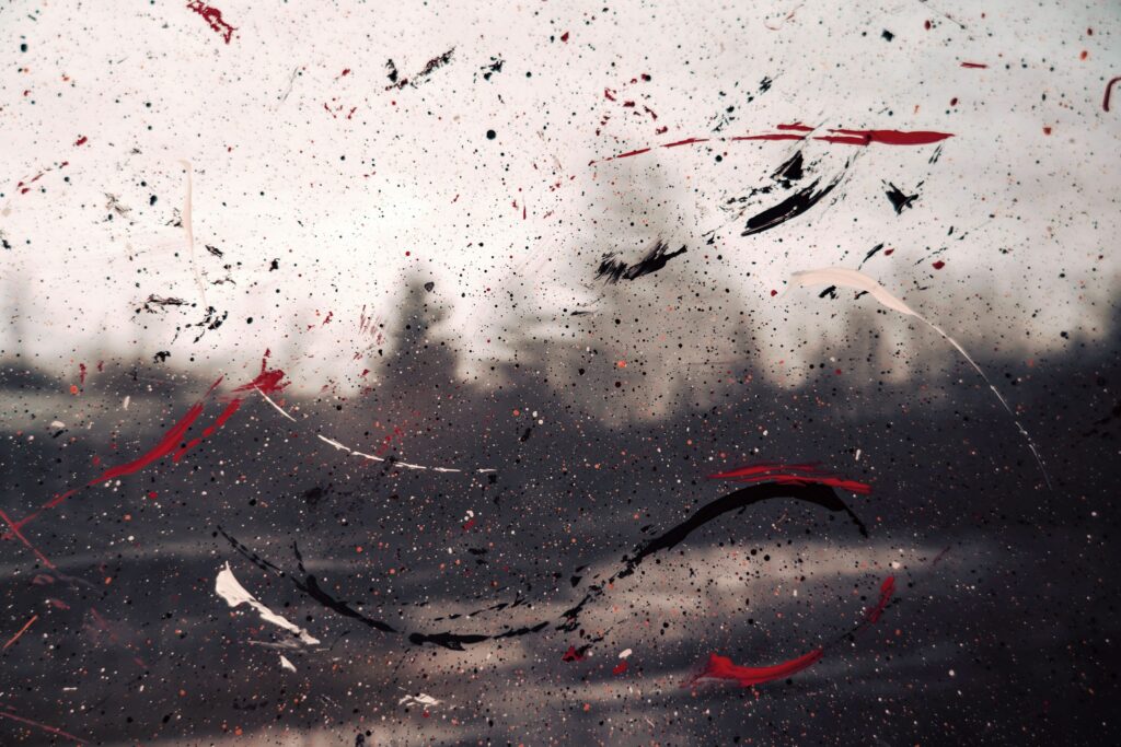 Abstract Wallpaper: Red & Black Paint Splatters with Blurry Background