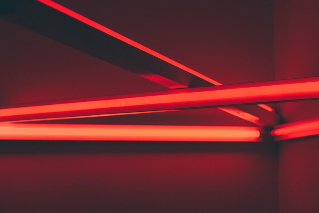 Vibrant Glow: A Contemporary Red LED Line Illuminating Abstract Background in 5K Wallpaper