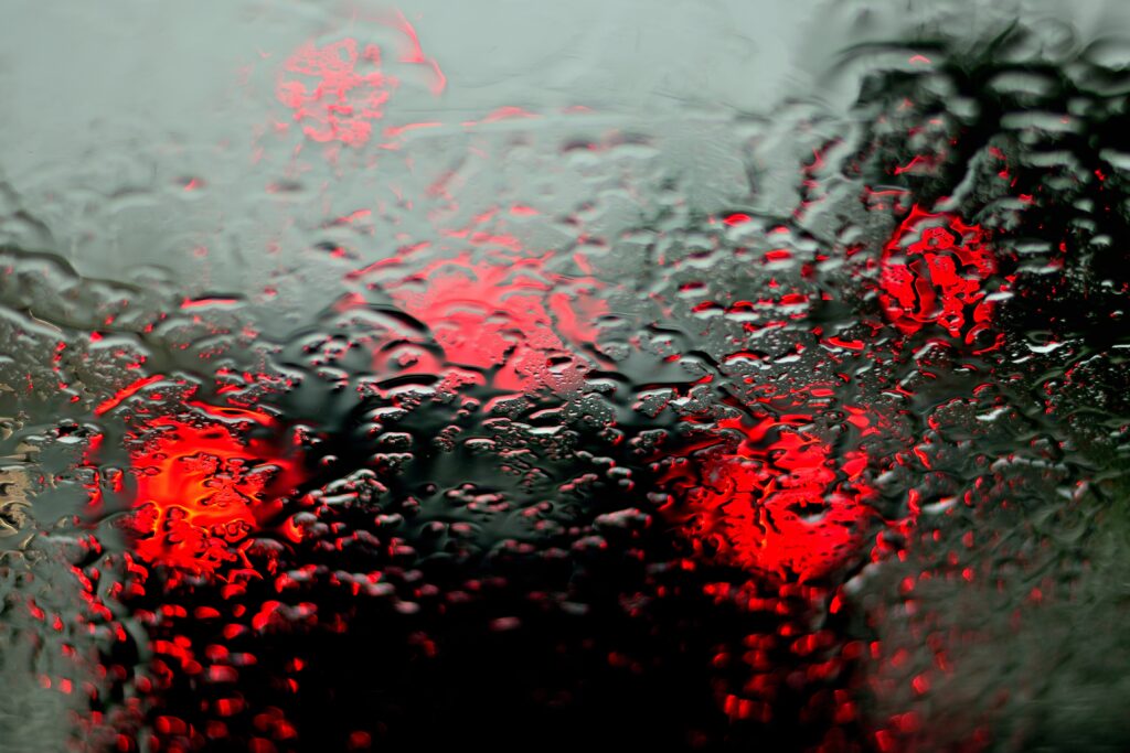 Macro Water Droplets on Reflective Surface with Abstract Red Lights Wallpaper