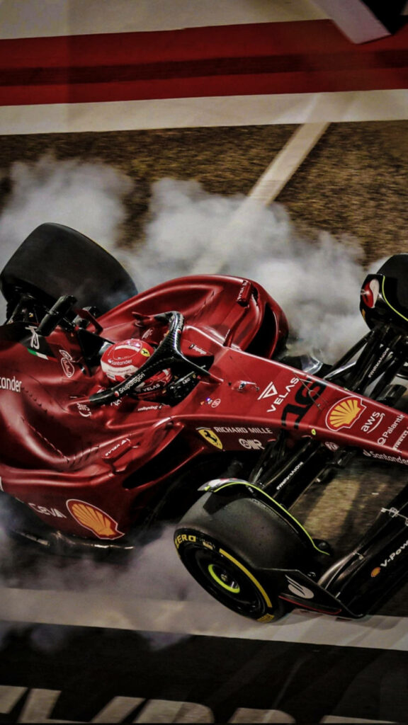 Sizzling Action: Scuderia Ferrari's Smoking Tire during Pit Stop Redemption - Stunning iPhone Shot Wallpaper