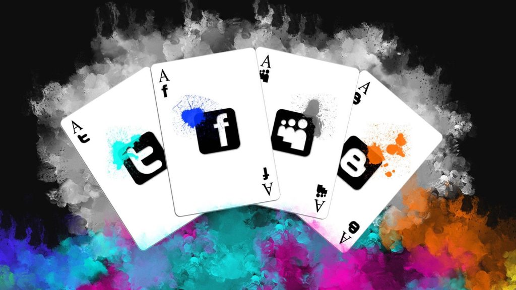 Digital art wallpaper with four Ace cards showing Tumblr Facebook MySpace Blogger logos smoky background