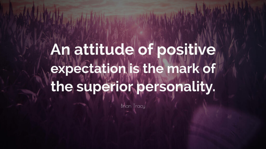 Embracing the Power of Positive Expectation: Inspiring Words by Brian Tracy amidst a Serene Violet Grass Background Wallpaper