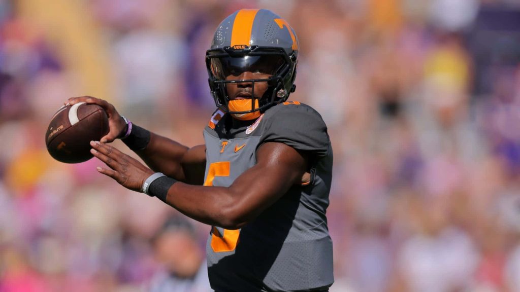 Hendon Hooker Tennessee Volunteers quarterback mid-throw in grey orange UT uniform stadium background Wallpaper