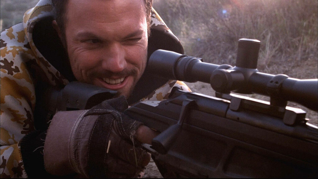 Adam Baldwin aiming hunting rifle in camouflage smiling outdoors rugged nature background wallpaper